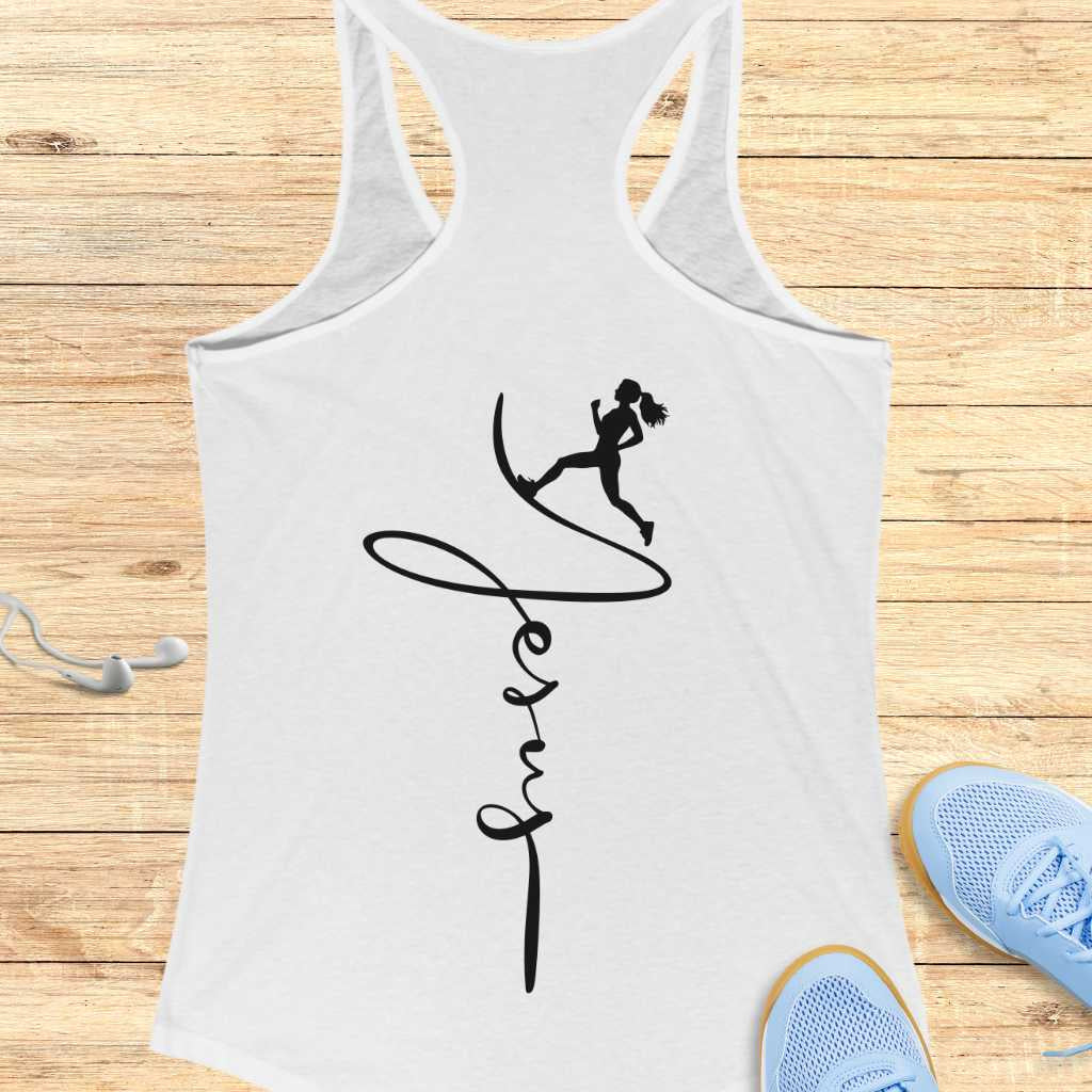 White tank top with black graphic design on a wooden surface with sneakers and earbuds.