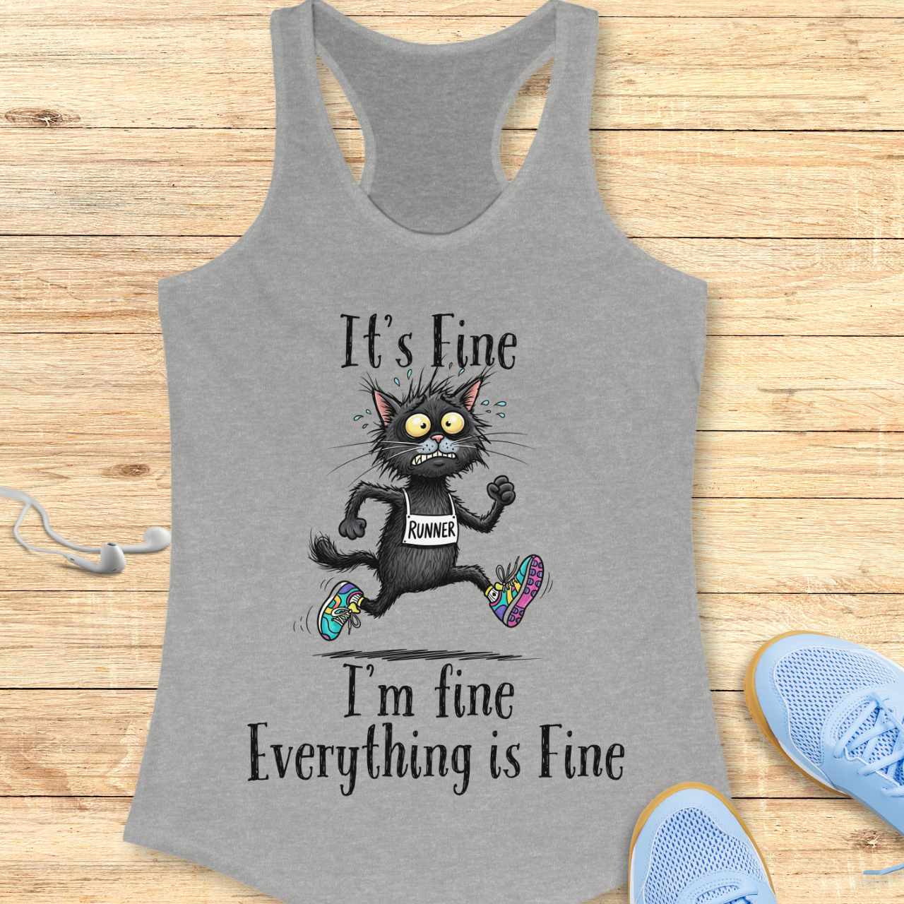 Screen-printed design on a grey racerback tank top featuring a frantic, sweating black cartoon cat wearing a "RUNNER" bib and mismatched colorful running shoes with the text "It's Fine" above and "I'm fine Everything is Fine" below