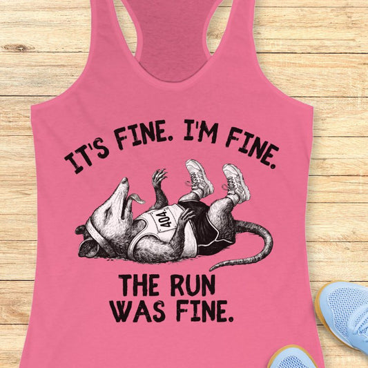Pink tank top with a graphic of a rat and text on a wooden surface