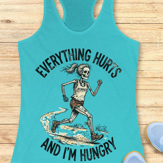 blue tank top with skeleton runner graphic and text 'Everything hurts and I'm hungry' on a wooden surface.