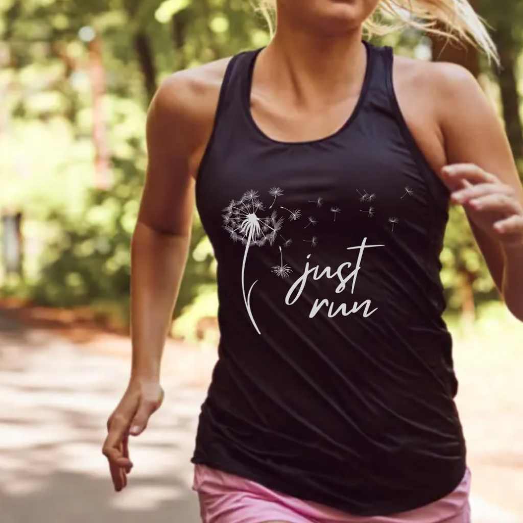 Woman running on a quiet road at sunrise, symbolizing healing, strength, and finding peace through running after loss.