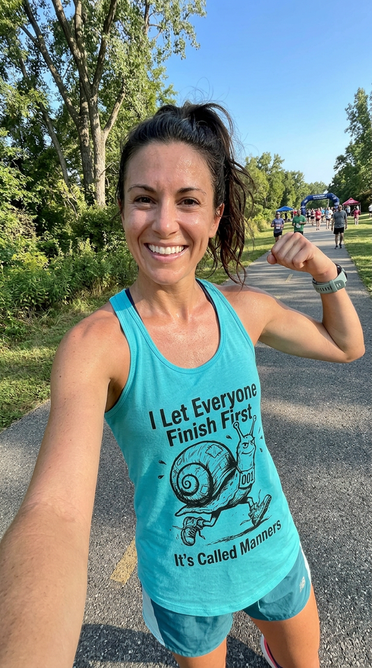 Women's running tank top with snail illustration and slogan "I Let Everyone Finish First. It's Called Manners" — slow runner pride apparel by Unleashed Threads