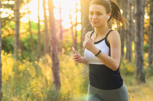 Woman running at sunrise on a quiet road, symbolizing the benefits of morning daily running such as fresh air, mental clarity, consistency, and cooler temperatures for marathon training and daily fitness.
