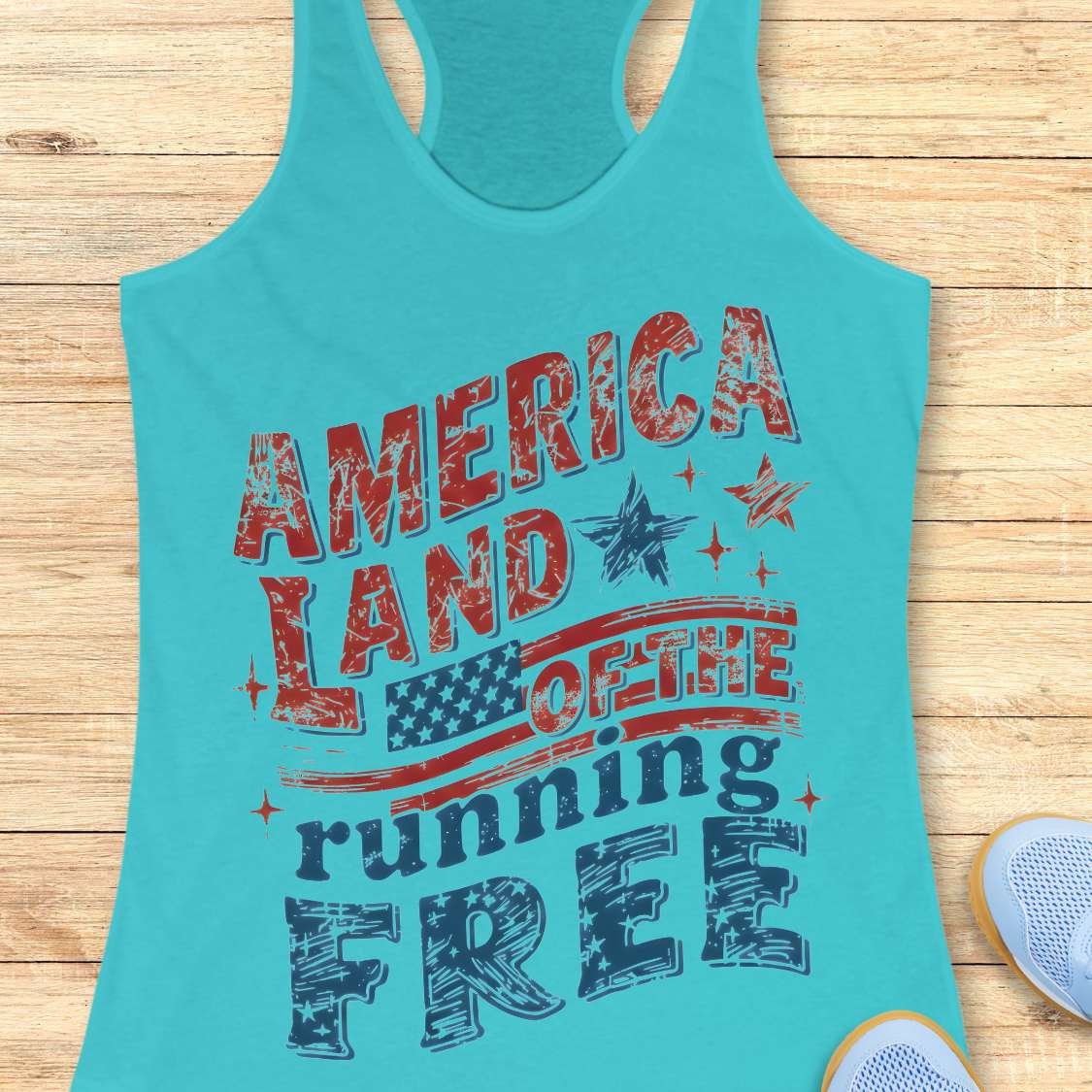 Turquoise tank top with 'America Land of the Running Free' text on a wooden surface