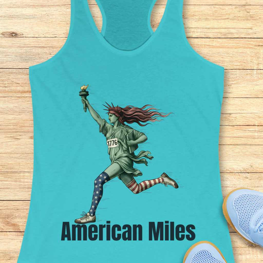 Graphic design on a teal tank top featuring the iconic Statue of Liberty running, holding her torch and tablet, wearing a race bib numbered "1776" and mismatched patriotic star and stripe socks, with the text "American Miles" printed below