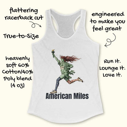 Product photograph of a white racerback tank top featuring a dynamic graphic of the Statue of Liberty running, holding a golden torch, wearing a green tunic with "1776" and distinct star-spangled and red-striped patriotic leggings, above "American Miles" text
