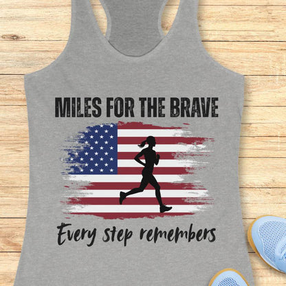 Gray tank top with American flag and running silhouette design on a wooden surface