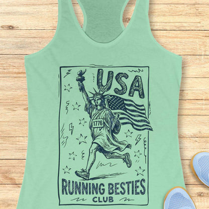 Mint green tank top with 'USA Running Besties Club' design on a wooden surface