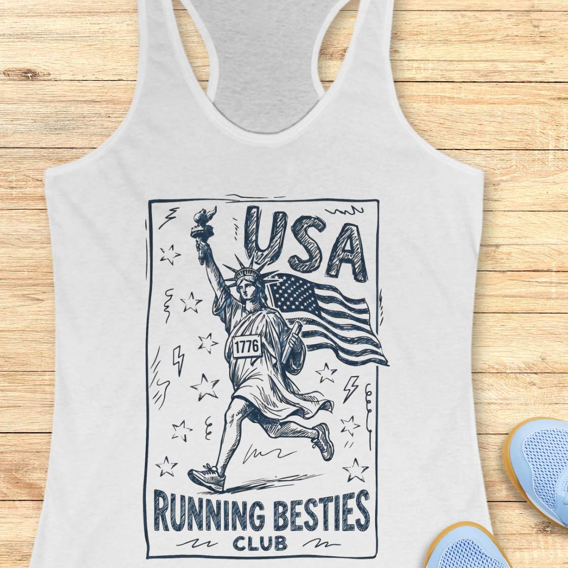 white tank top with 'USA Running Besties Club' design on a wooden surface