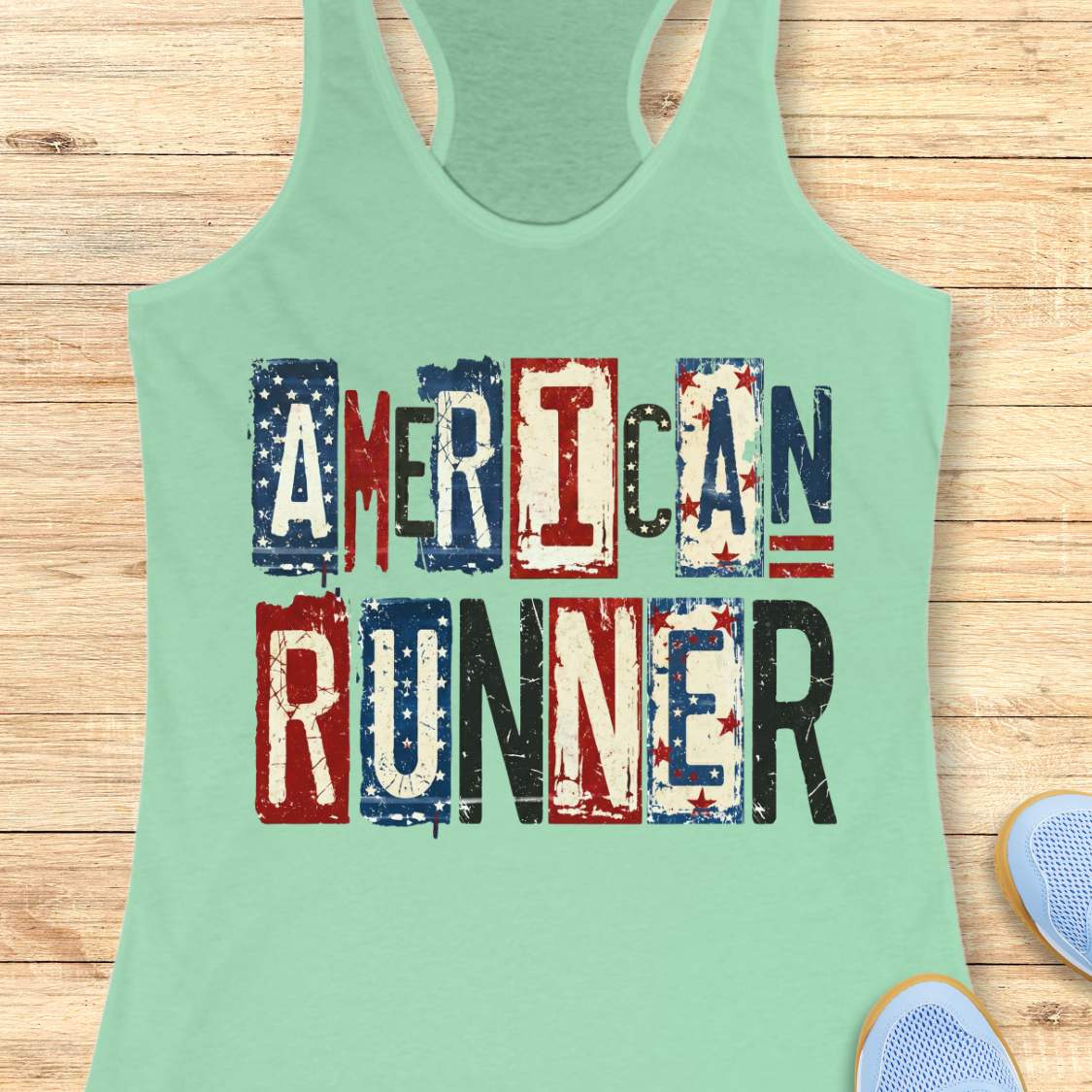 Mint green tank top with 'American Runner' text on a wooden surface