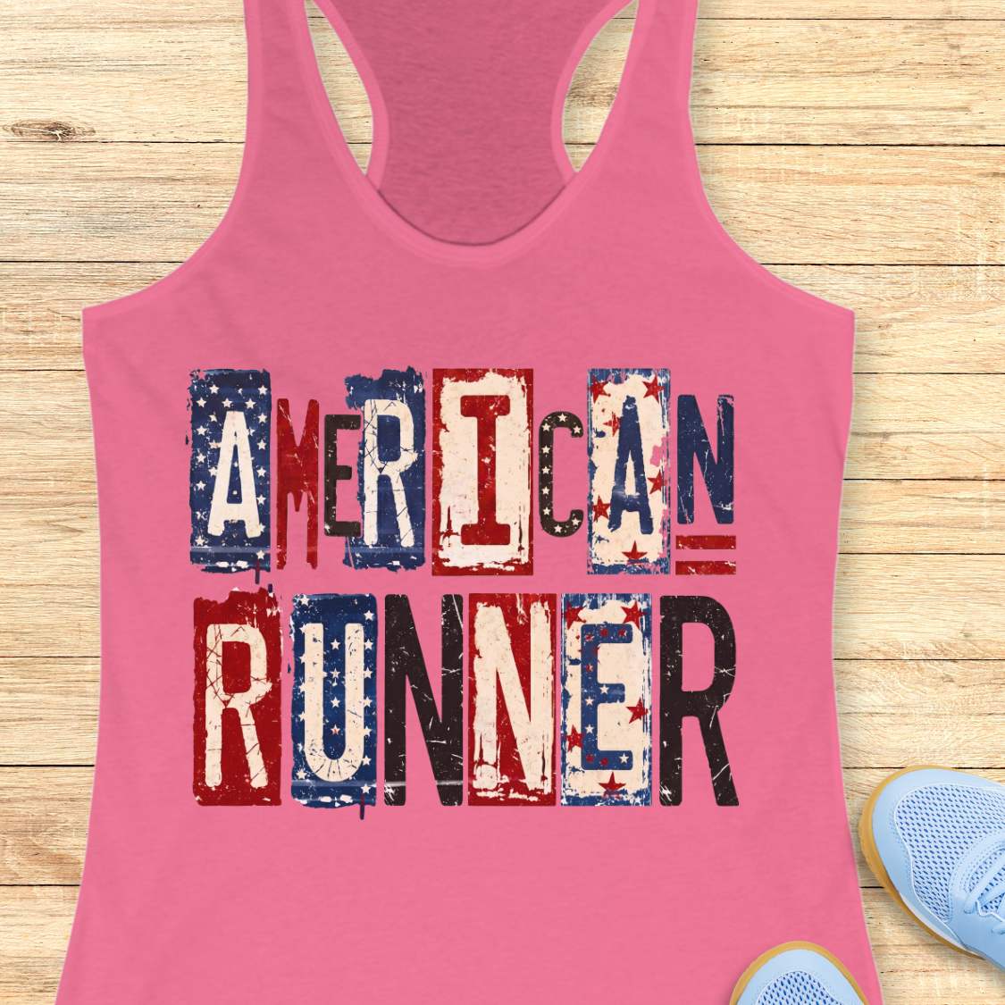 Pink tank top with 'American Runner' text on a wooden surface
