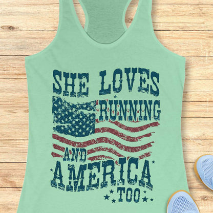 Mint green tank top with 'She Loves Running and America Too' text on a wooden surface