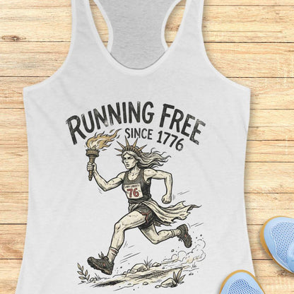 white tank top with a design of lady liberty running and text - 'running free since 1776', on a wooden surface.