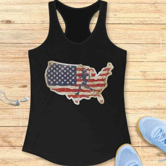 Black racerback tank top with a distressed American flag USA map graphic featuring a runner silhouette, shown on a light wooden background with white earphones and light blue athletic shoes