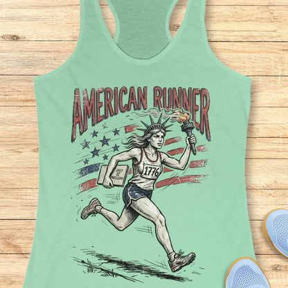 mint tank top with a design of lady liberty running and text - 'American runner, on a wooden surface.