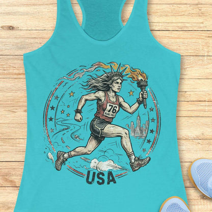 Turquoise tank top with a graphic of lady liberty as a runner and 'USA' text on a wooden surface