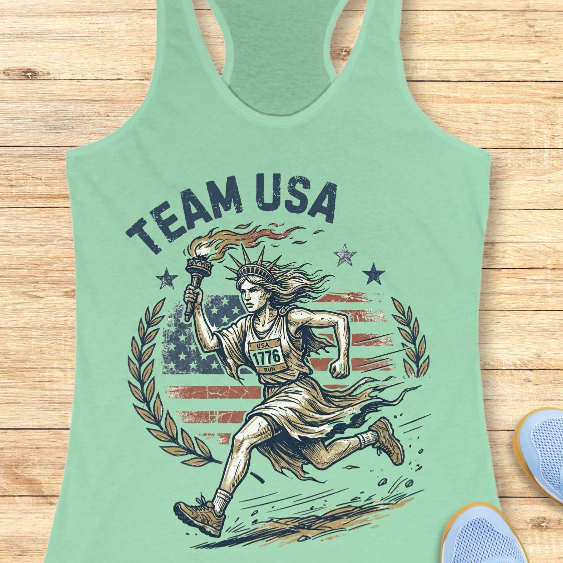Green tank top with 'Team USA' design featuring lady liberty running and American flag on a wooden surface.