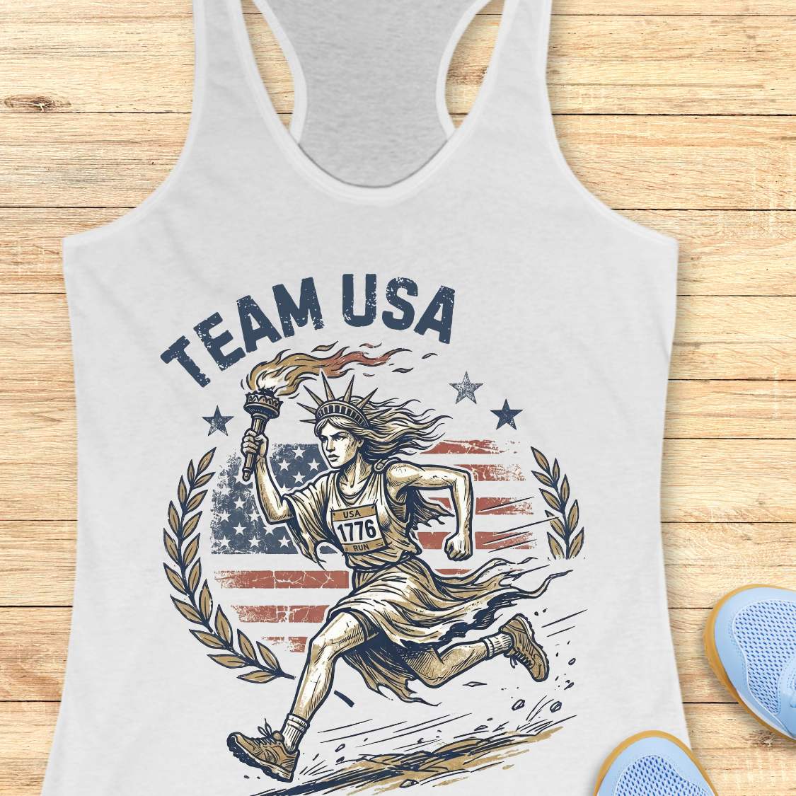 white tank top with 'Team USA' design featuring lady liberty running and American flag on a wooden surface.