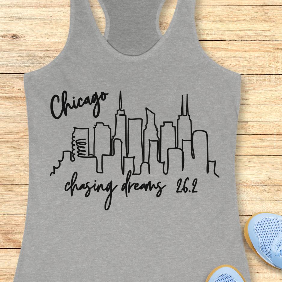 grey tank top with the text- Chicago, chasing dreams 26.2, with an image of Chicago skyline. on a wooden background