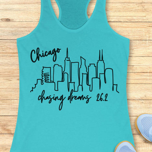 blue tank top with the text- Chicago, chasing dreams 26.2, with an image of Chicago skyline. on a wooden background