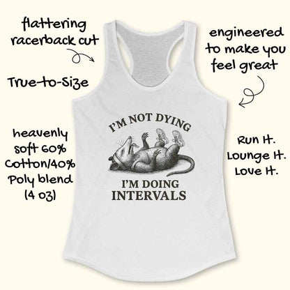White racerback tank top featuring a detailed black and white illustration of an opossum wearing sneakers and a headband lying on its back, accompanied by the humorous text I'M NOT DYING I'M DOING INTERVALS and additional product features like flattering cut and soft cotton-poly blend