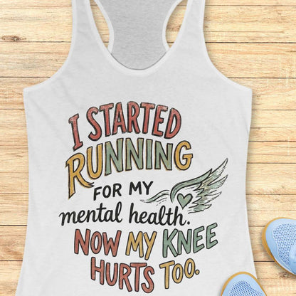 White tank top with motivational quote on a wooden surface
