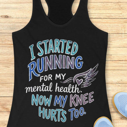Black tank top with humorous running text design on a wooden surface