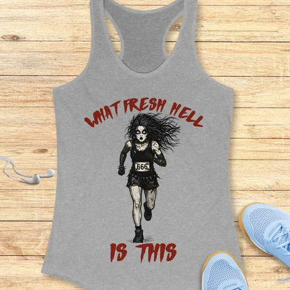 A gray tank top featuring a graphic print of a pale gothic runner with dark eye makeup, wild black hair, wearing a black tank top and ripped skirt with a "666" race bib, alongside red distressed text "WHAT FRESH HELL IS THIS", displayed on a wooden surface with light blue sneakers and white earbuds