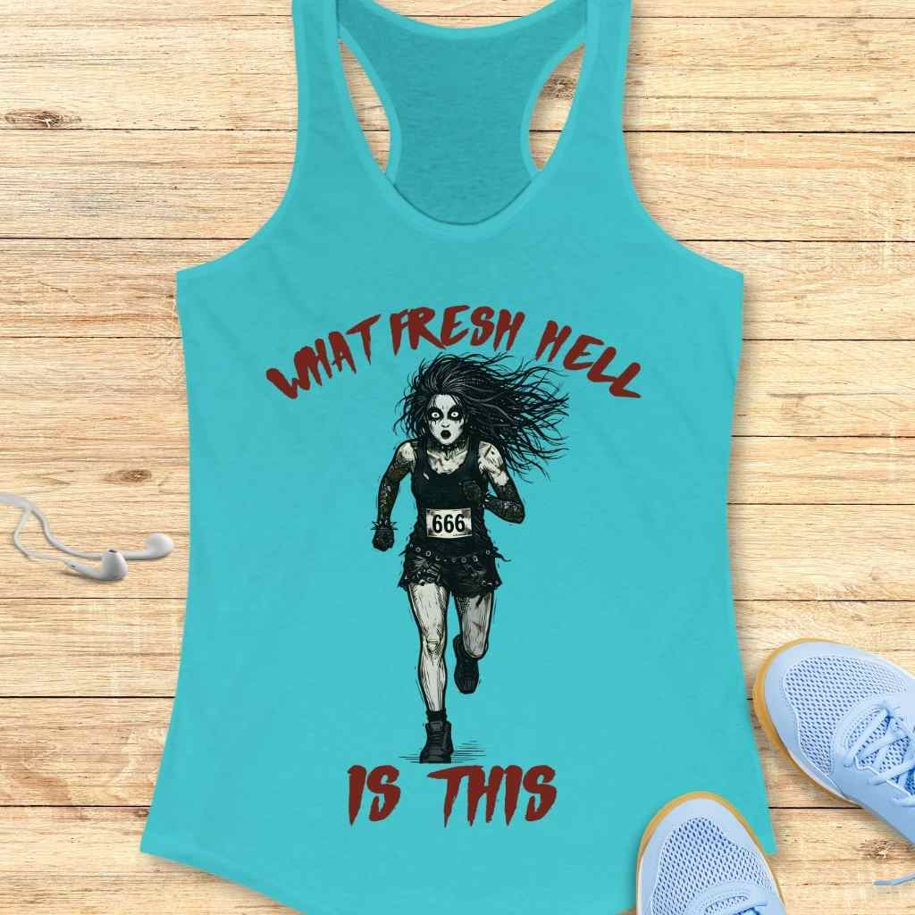 Turquoise tank top featuring a graphic of a pale, wild-haired runner in black with a 666 race bib and red text reading What Fresh Hell Is This, displayed on light wooden planks alongside light blue sneakers and white earbuds