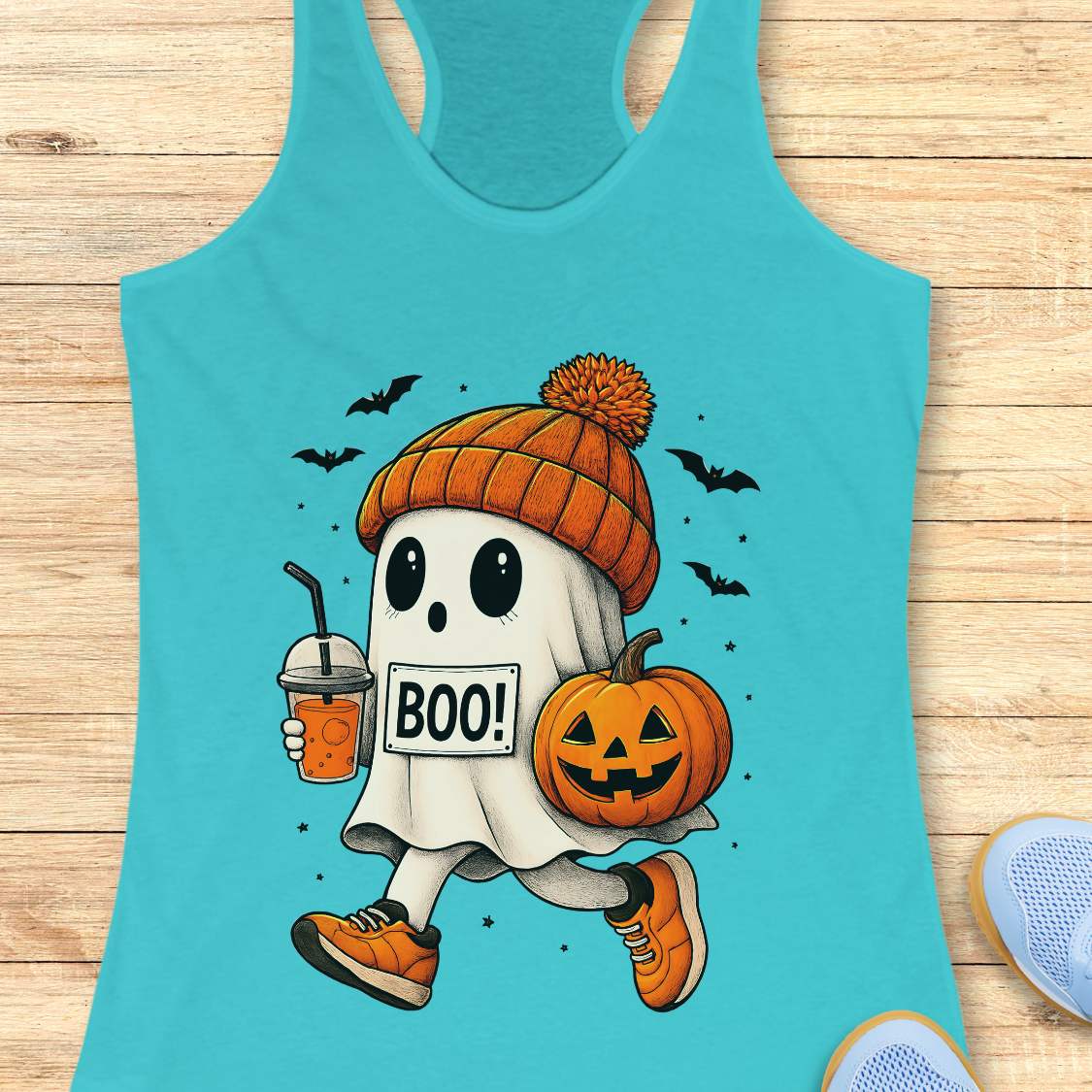 blue tank top with Halloween ghost design on a wooden surface