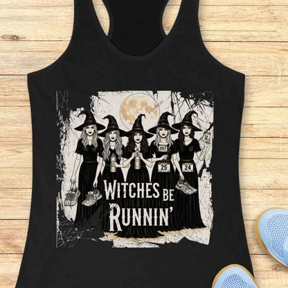 Graphic print on tank top depicting five cartoon witches in black dresses and pointed hats holding running shoes and water bottles, sporting race bibs with numbers 2017, 25, and 24, all set against a full moon and distressed background, with the phrase Witches Be Runnin