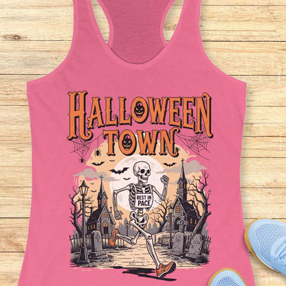 pink tank top with Halloween-themed design and a text ' Halloween town', on a wooden surface
