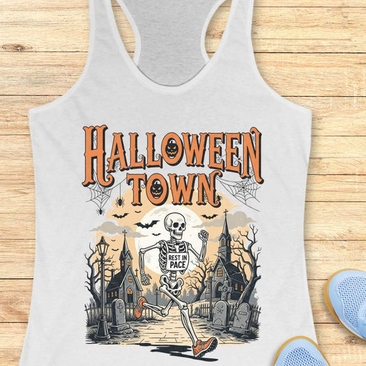 white tank top with Halloween-themed design and a text ' Halloween town', on a wooden surface