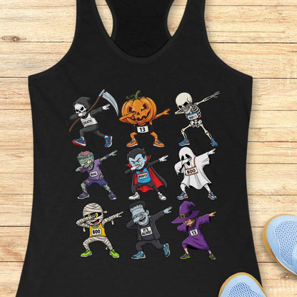 Digital illustration on a black racerback tank top showcasing nine dabbing Halloween cartoon characters including a Grim Reaper, pumpkin, skeleton, zombie, vampire, ghost, mummy, Frankenstein's monster, and a witch, many wearing race bibs like 'DEATH' or 'BOO,' displayed on a rustic wooden background with blue sneakers and white earbuds nearby