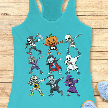 Digital illustration on a blue racerback tank top showcasing nine dabbing Halloween cartoon characters including a Grim Reaper, pumpkin, skeleton, zombie, vampire, ghost, mummy, Frankenstein's monster, and a witch, many wearing race bibs like 'DEATH' or 'BOO,' displayed on a rustic wooden background with blue sneakers and white earbuds nearby