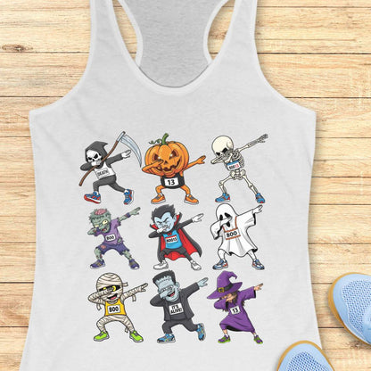 Digital illustration on a white racerback tank top showcasing nine dabbing Halloween cartoon characters including a Grim Reaper, pumpkin, skeleton, zombie, vampire, ghost, mummy, Frankenstein's monster, and a witch, many wearing race bibs like 'DEATH' or 'BOO,' displayed on a rustic wooden background with blue sneakers and white earbuds nearby