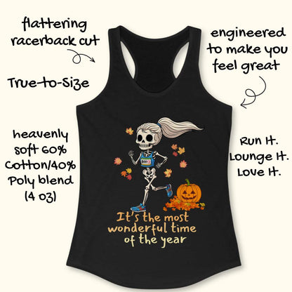 Graphic design on a black tank top features a female skeleton with a ponytail wearing a blue running bib B0013 and blue sneakers, running past a smiling jack-o'-lantern and colorful autumn leaves, with the text It's the most wonderful time of the year