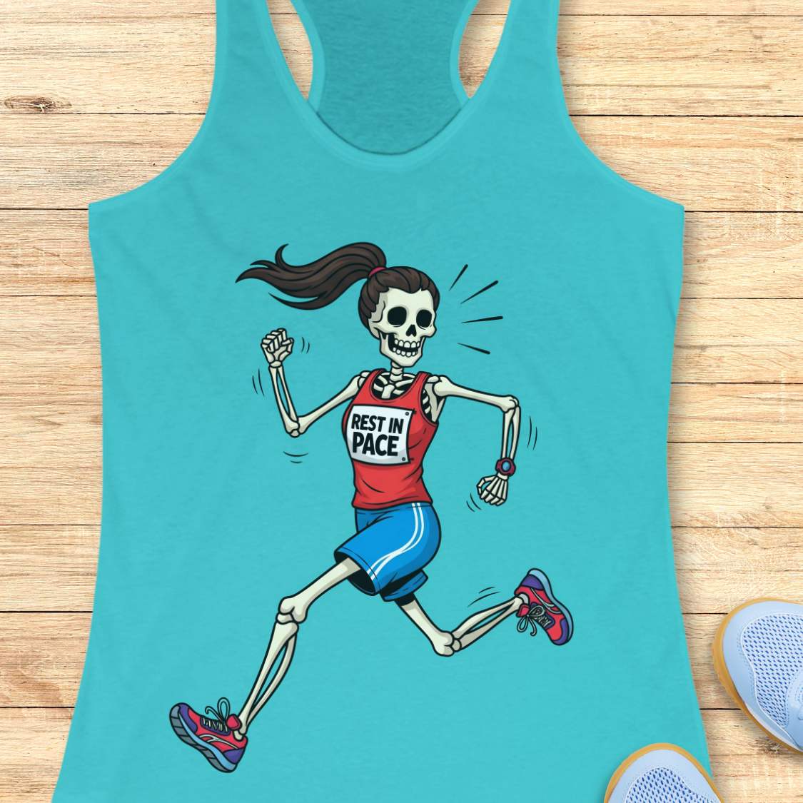 Graphic design on a blue tank top featuring a female skeleton with a ponytail running in a red 'REST IN PACE' top, blue shorts, colorful athletic shoes, and a fitness watch, laid flat on a light wood surface with white earbuds and light blue sneakers