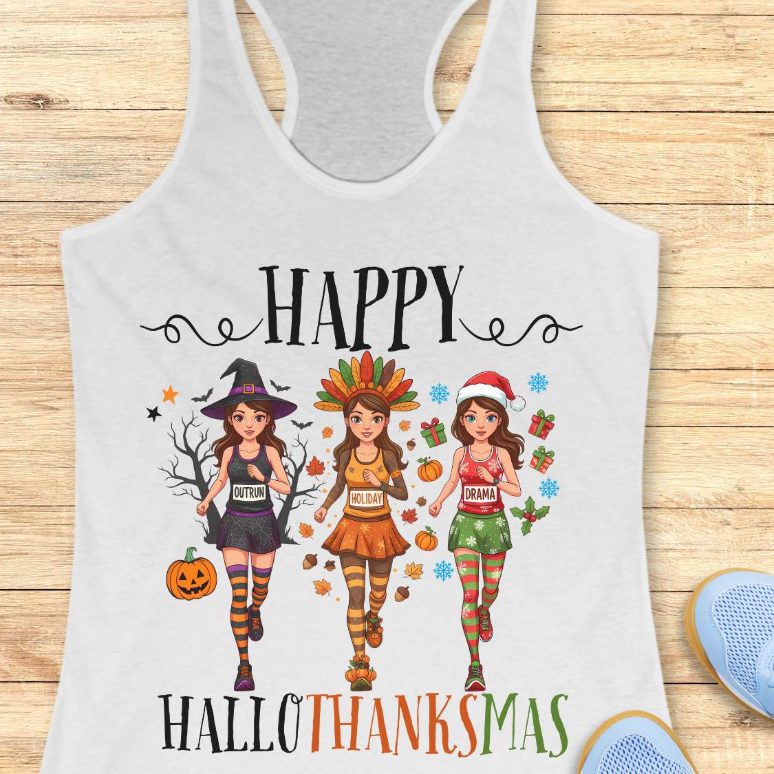 white tank top with 'Happy HalloThanksMas' design on a wooden surface