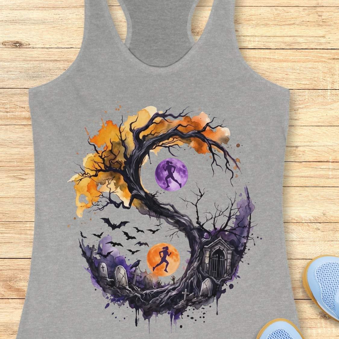 grey tank top with Halloween ying and yang graphic design , on a wooden surface