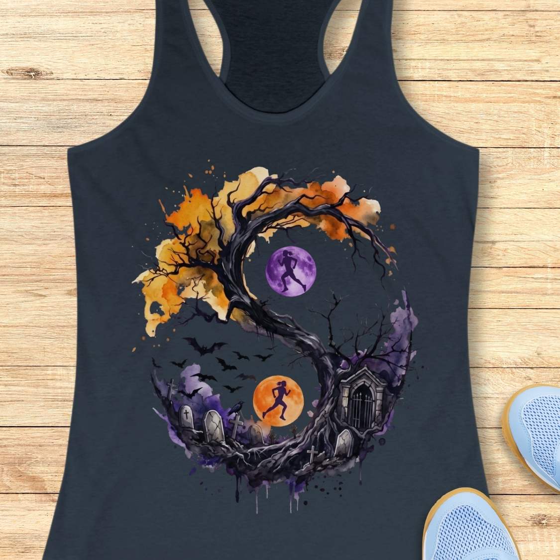 indigo tank top with Halloween ying and yang graphic design , on a wooden surface