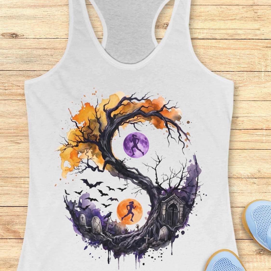 white tank top with Halloween ying and yang graphic design , on a wooden surface