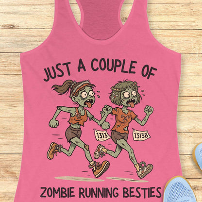 pink racerback tank top featuring the phrase “JUST A COUPLE OF” above two cartoon zombie runners and “ZOMBIE RUNNING BESTIES” below. The two zombie friends are running side by side wearing race bibs numbered 1313 and 1313B, with tattered running clothes, messy hair, and humorous zombie details. The playful Halloween-themed design combines friendship and running with a spooky, fun aesthetic perfect for runners who love Halloween.