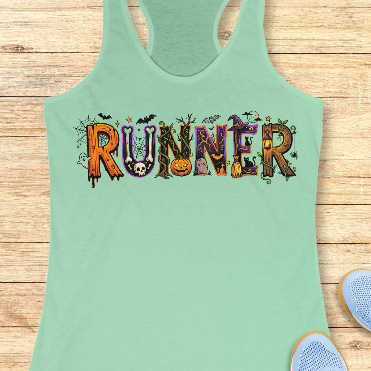 mint racerback tank top featuring the word “RUNNER” in large Halloween-themed decorative letters. Each letter is uniquely styled with spooky elements including spider webs, bats, a skull, twisting vines, a jack-o'-lantern, a gravestone marked “R.I.P.,” a witch’s hat, a broomstick, black cats, a lantern, a ghost, and a full moon. The colorful orange, purple, black, and green artwork creates a fun and festive Halloween design for runners who love spooky season.