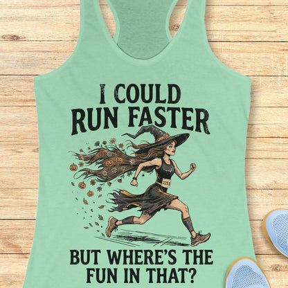 mint racerback tank top featuring the humorous Halloween running quote, “I COULD RUN FASTER BUT WHERE’S THE FUN IN THAT?” The design shows a witch runner wearing a pointed hat, flowing tattered dress, and race bib number 2253, sprinting forward. Her long hair trails behind her, filled with autumn leaves, flowers, and small jack-o'-lanterns, creating a magical motion effect. The artwork combines running motivation with spooky Halloween charm, making it perfect for runners who prefer enjoying the journey over