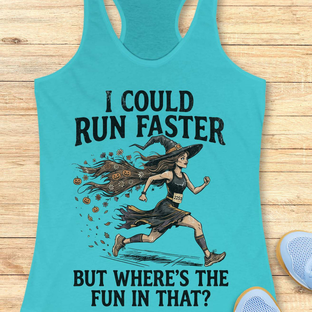 blue racerback tank top featuring the humorous Halloween running quote, “I COULD RUN FASTER BUT WHERE’S THE FUN IN THAT?” The design shows a witch runner wearing a pointed hat, flowing tattered dress, and race bib number 2253, sprinting forward. Her long hair trails behind her, filled with autumn leaves, flowers, and small jack-o'-lanterns, creating a magical motion effect. The artwork combines running motivation with spooky Halloween charm, making it perfect for runners who prefer enjoying the journey over