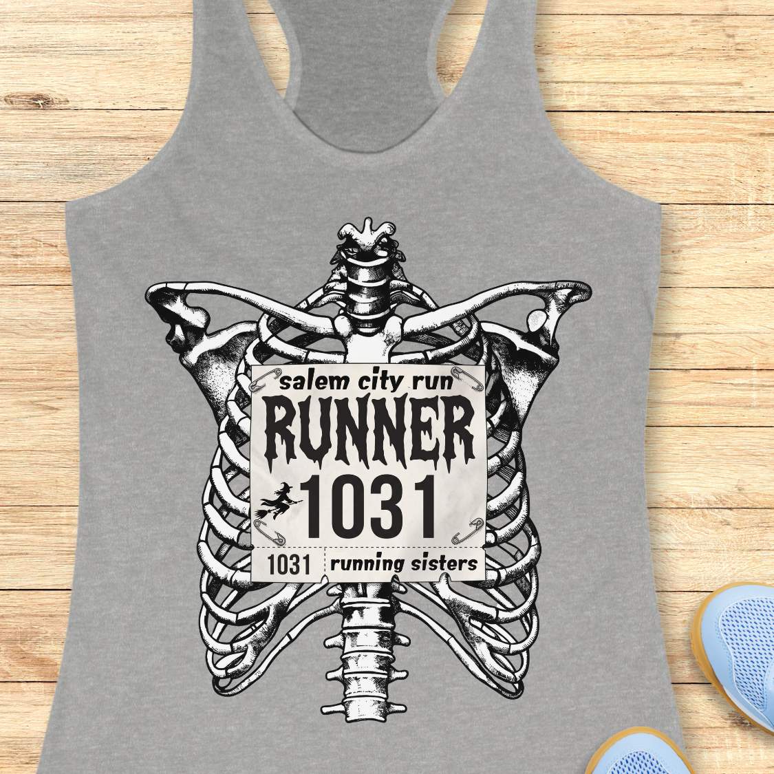 Funny Halloween running grey tank top featuring a detailed black-and-white skeleton ribcage with a vintage race bib pinned across the chest. The bib reads “Salem City Run,” “RUNNER 1031,” and “1031 Running Sisters,” with spooky gothic typography and a small witch silhouette on a broomstick. The design is printed on a black racerback tank top and combines witchy Salem vibes, Halloween aesthetics, and women's running culture.