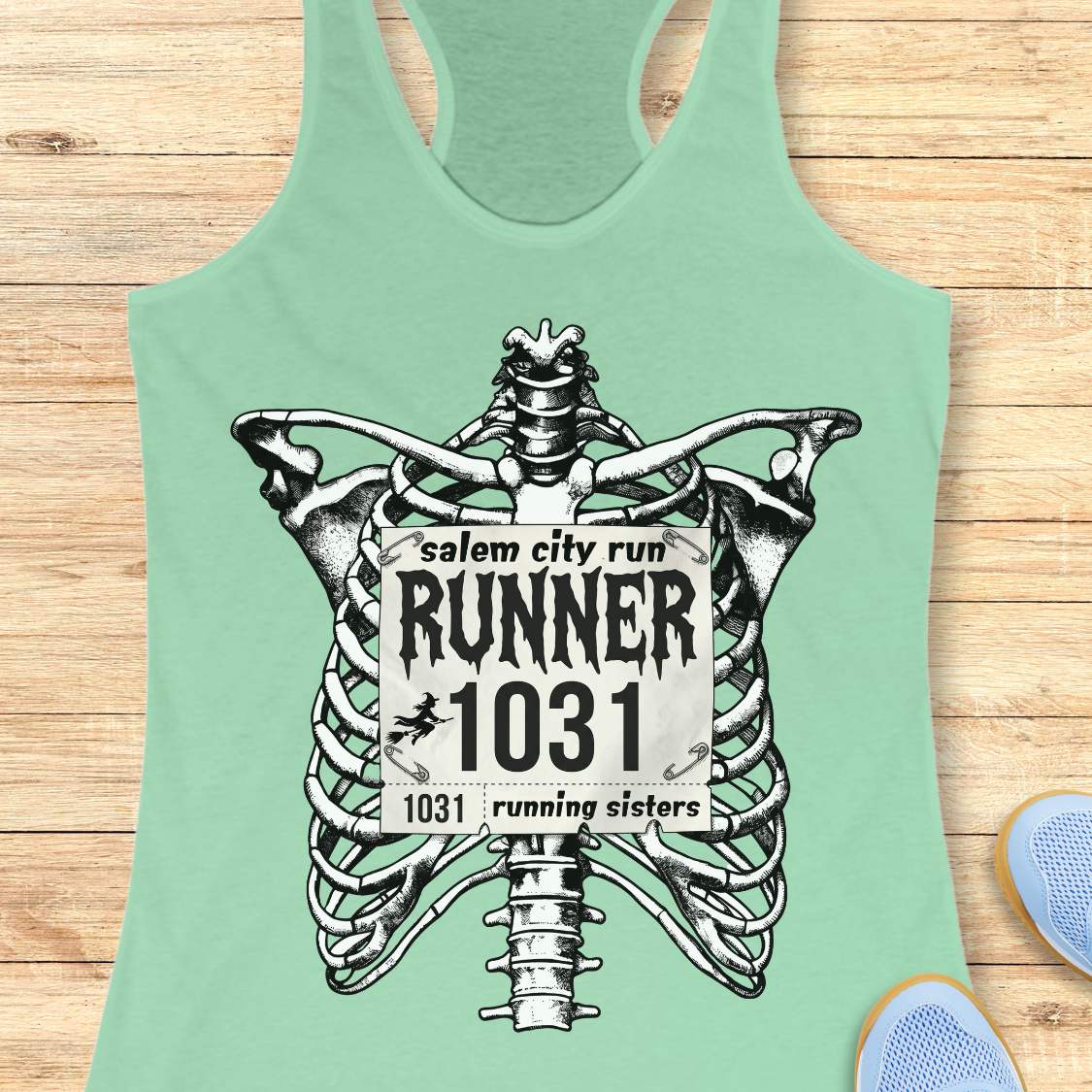 Funny Halloween running mint tank top featuring a detailed black-and-white skeleton ribcage with a vintage race bib pinned across the chest. The bib reads “Salem City Run,” “RUNNER 1031,” and “1031 Running Sisters,” with spooky gothic typography and a small witch silhouette on a broomstick. The design is printed on a black racerback tank top and combines witchy Salem vibes, Halloween aesthetics, and women's running culture.