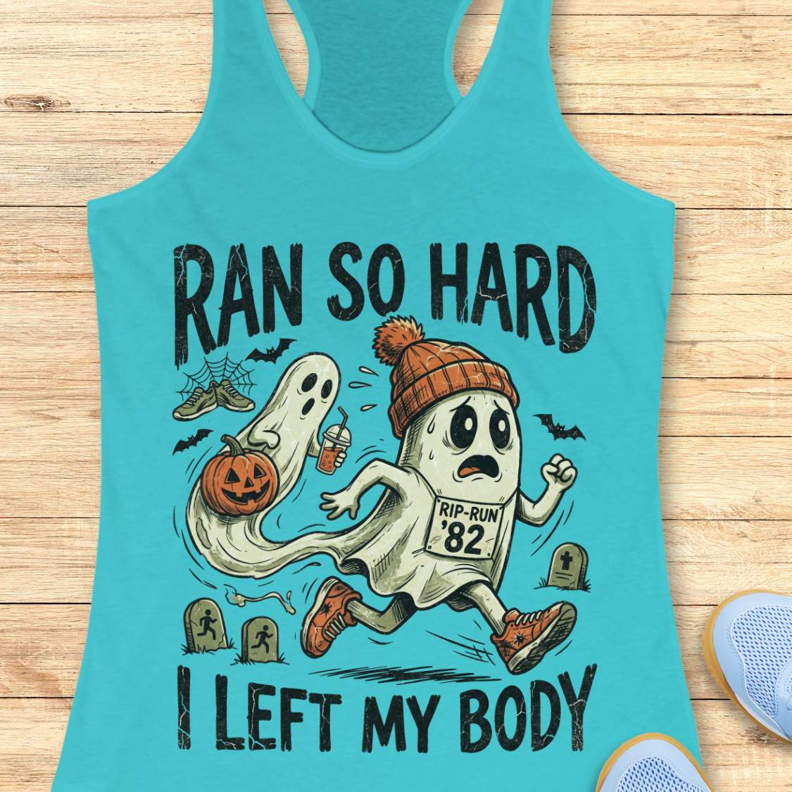 blue Halloween tank top with an image of a running ghost and text 'Ran so hard I left my body', on a wooden surface