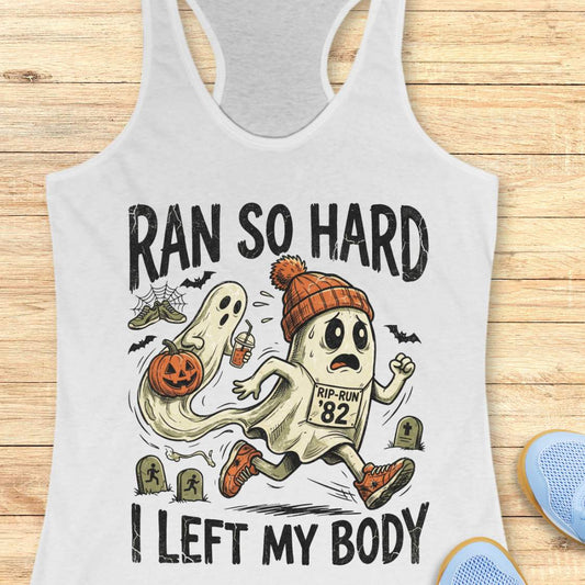 white Halloween tank top with an image of a running ghost and text 'Ran so hard I left my body', on a wooden surface